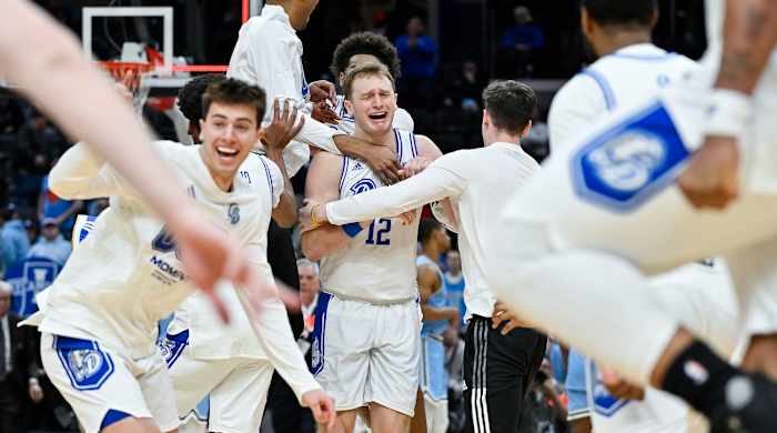 Drake Bulldogs guard Tucker DeVries (12) celebrates with teammates after Drake defeated the Indiana State Sycamores to win the Missouri Valley Conference Tournament Championship at Enterprise Center in St. Louis on March 10, 2024.
